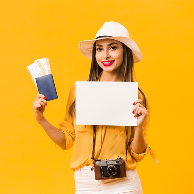 woman-carrying-camera-holding-plane-tickets-passport